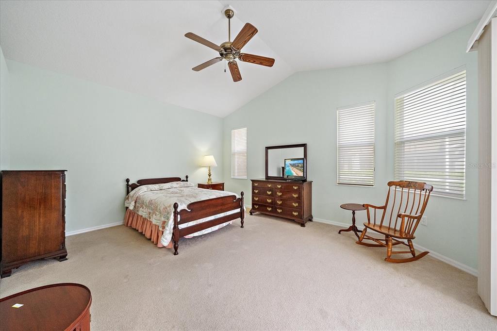 6476 Rookery Circle Bradenton, FL 34203 - Photo 16 of 44 a bedroom with a bed chair and window