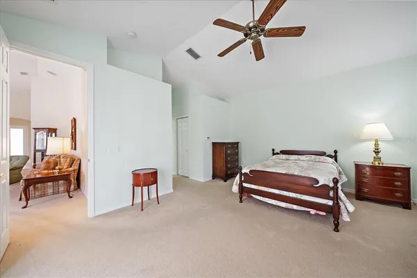 a bedroom with furniture and a chandelier