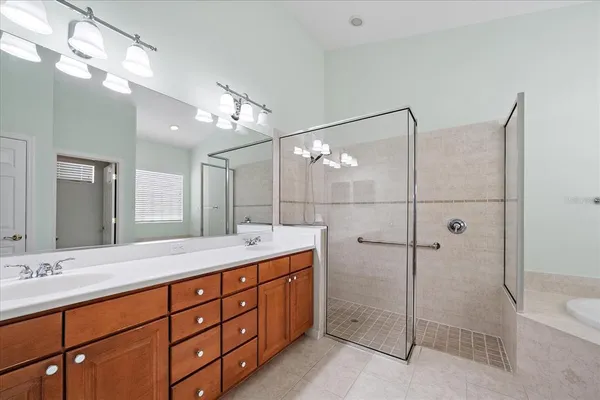 a bathroom with a shower sink double and mirror