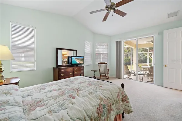a bedroom with a large bed and a tv
