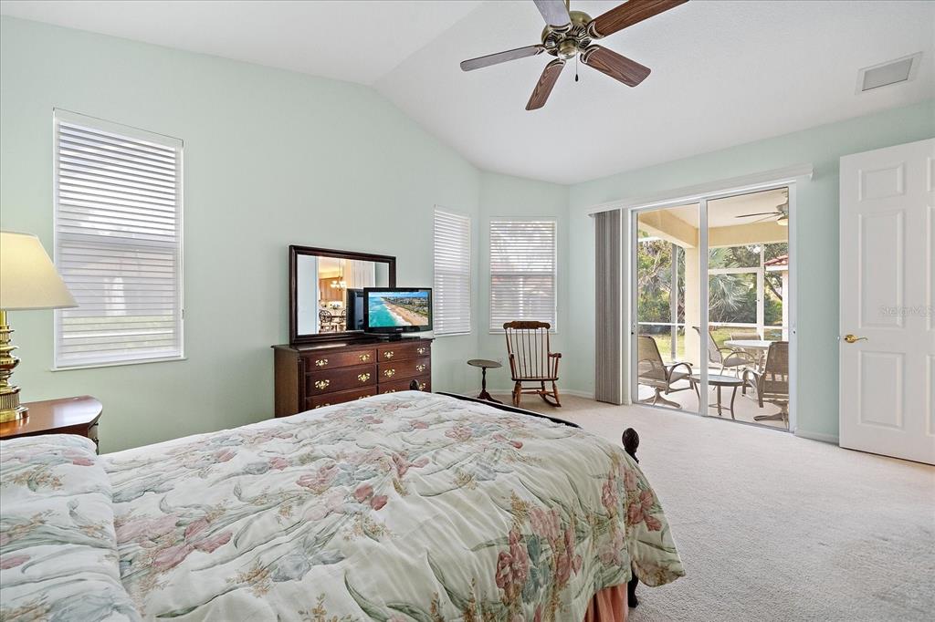 6476 Rookery Circle Bradenton, FL 34203 - Photo 20 of 44 a bedroom with a large bed and a tv