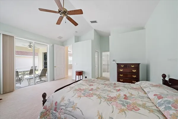 a bedroom with a bed and a large mirror