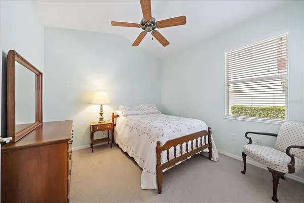 a bedroom with a bed chair and window