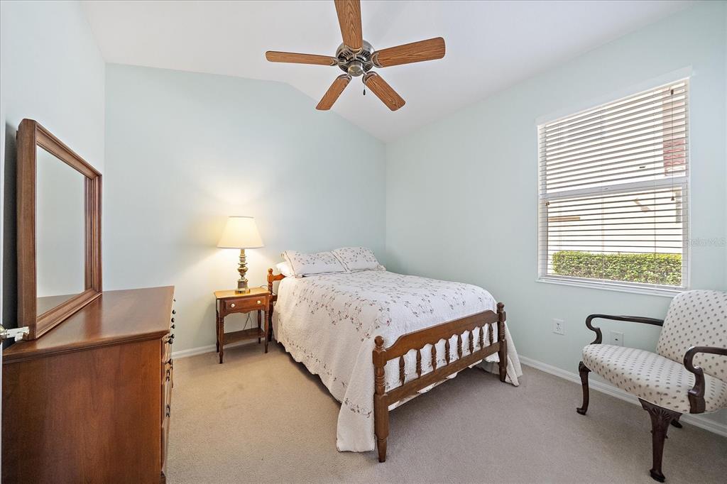6476 Rookery Circle Bradenton, FL 34203 - Photo 22 of 44 a bedroom with a bed chair and window