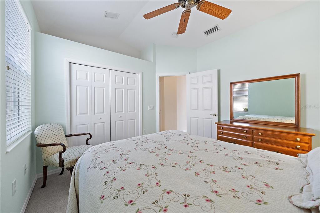 6476 Rookery Circle Bradenton, FL 34203 - Photo 23 of 44 a bedroom with a bed and a chandelier