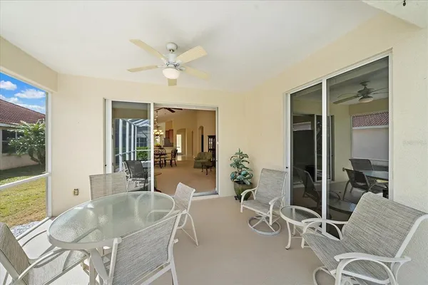 a dining room with furniture a potted plant and a chandelier