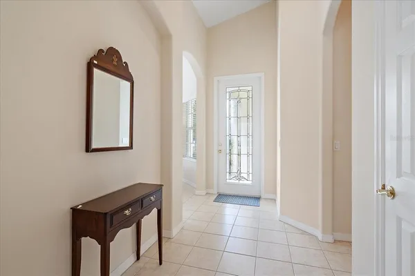 an empty room with windows and cabinet