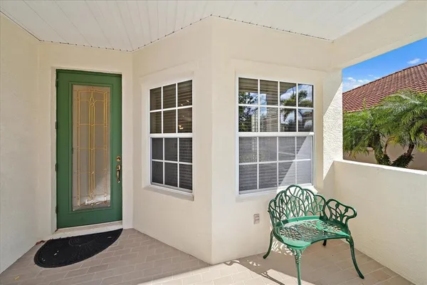 a view of a room that has a window and a chair