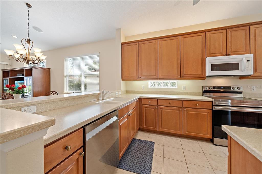 6476 Rookery Circle Bradenton, FL 34203 - Photo 5 of 44 a kitchen with stainless steel appliances granite countertop a sink and cabinets