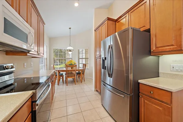 a kitchen with stainless steel appliances granite countertop a refrigerator and a stove top oven