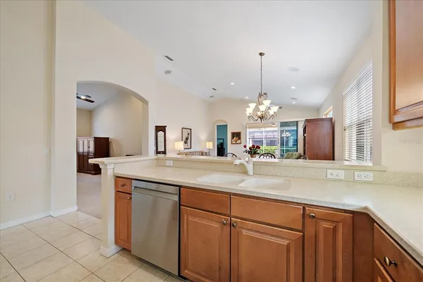 a view of a kitchen with a sink and a chandelier