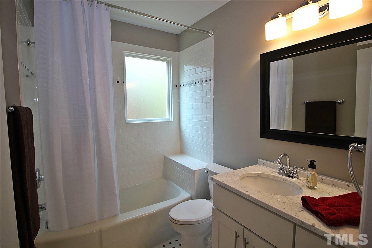 1204 Mitchell Street Raleigh, NC 27607 - Photo 12 of 22 a bathroom with a granite countertop sink toilet and shower