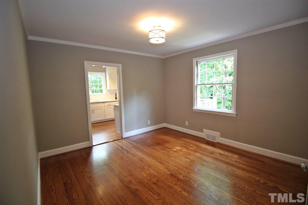 1204 Mitchell Street Raleigh, NC 27607 - Photo 15 of 22 an empty room with wooden floor and windows
