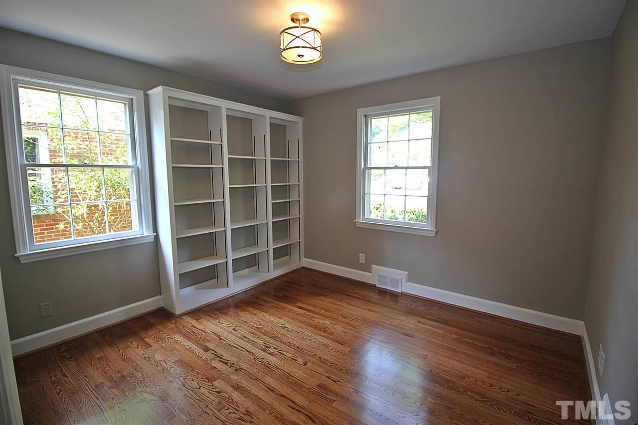 1204 Mitchell Street Raleigh, NC 27607 - Photo 16 of 22 a view of an empty room with a window and wooden floor