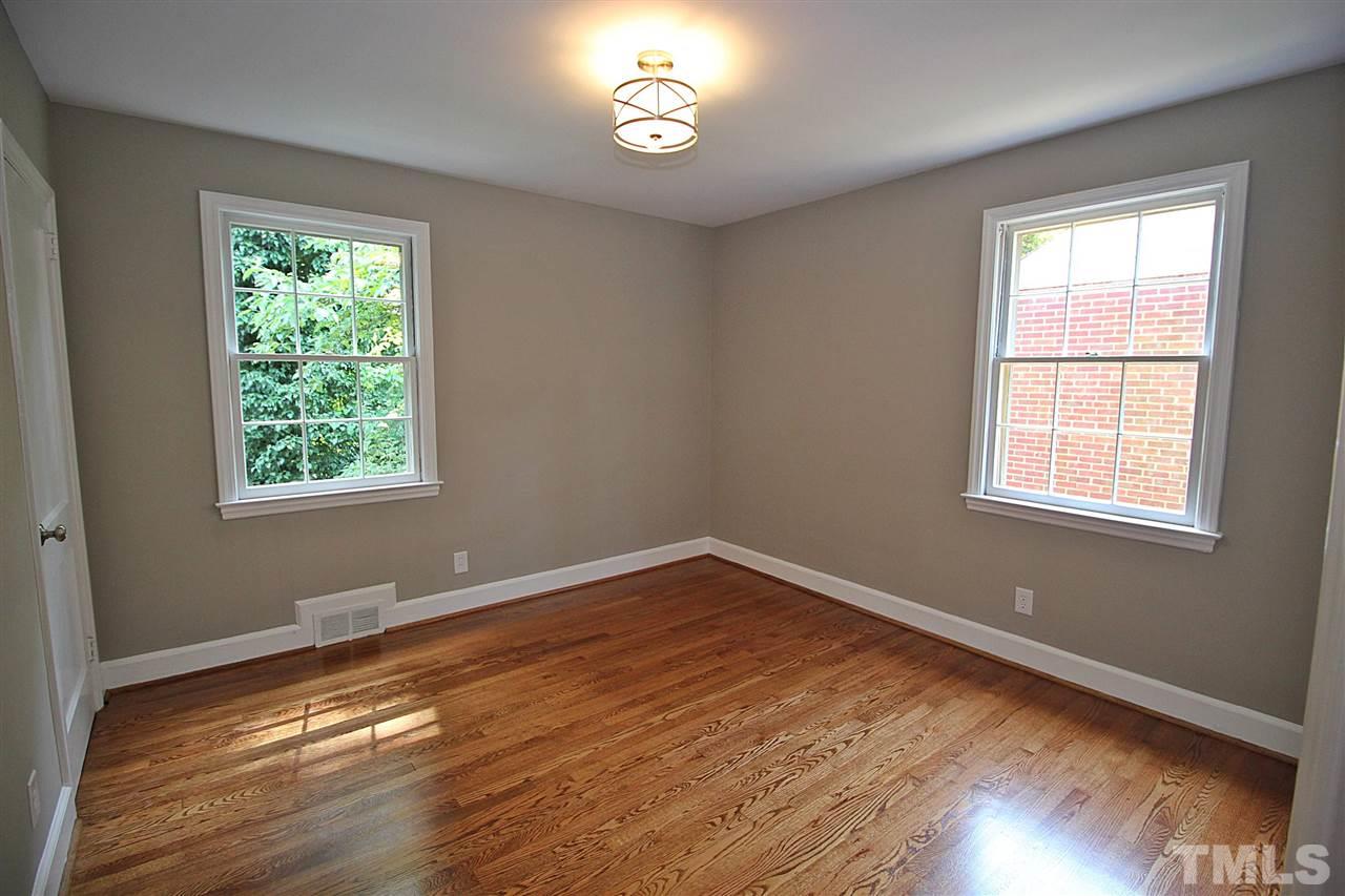 1204 Mitchell Street Raleigh, NC 27607 - Photo 17 of 22 a view of an empty room with wooden floor and a window