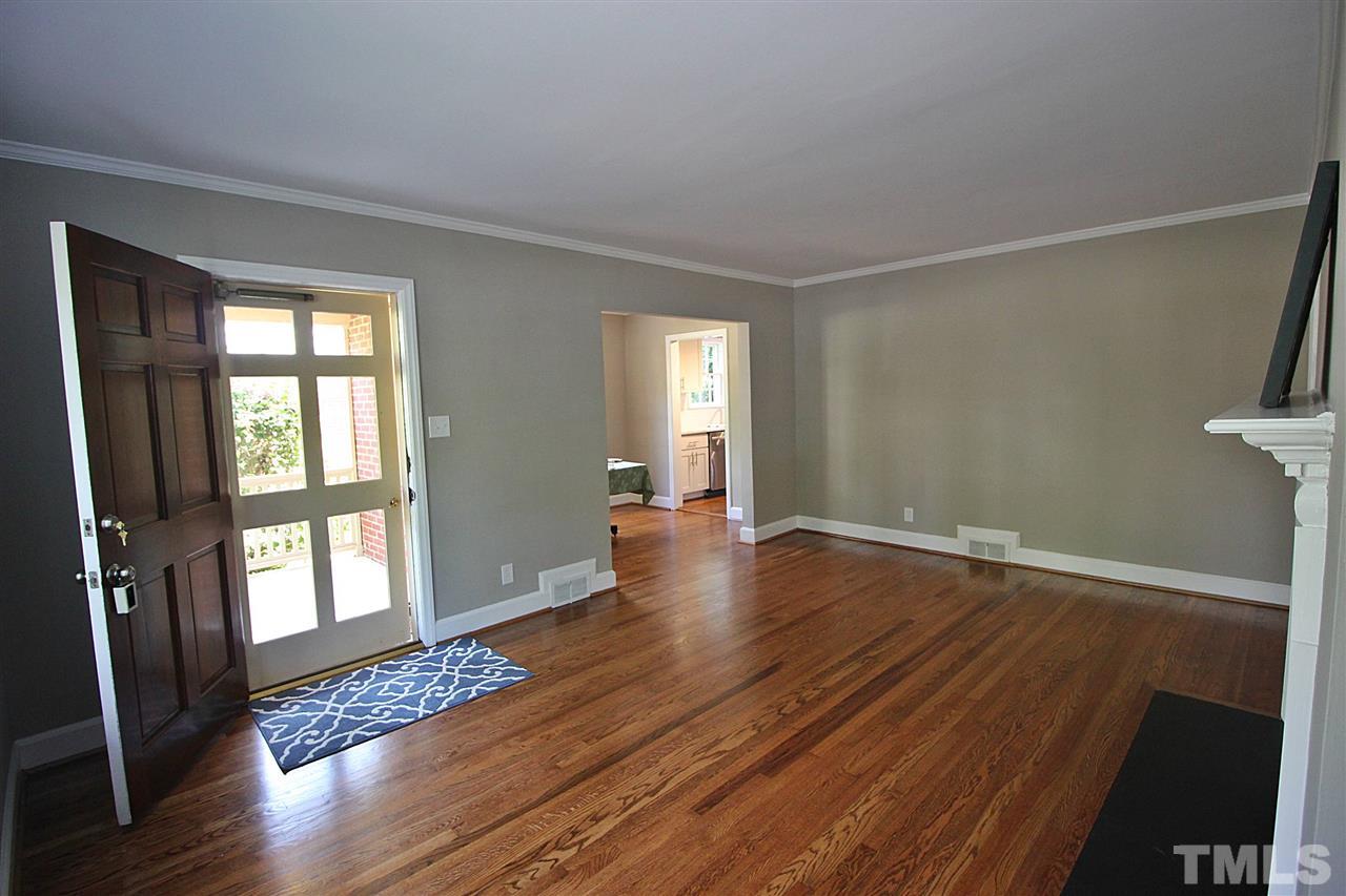 1204 Mitchell Street Raleigh, NC 27607 - Photo 3 of 22 a view of an empty room with wooden floor and a window