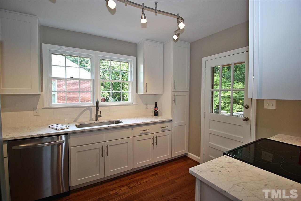 1204 Mitchell Street Raleigh, NC 27607 - Photo 8 of 22 a kitchen with a sink stove and cabinets