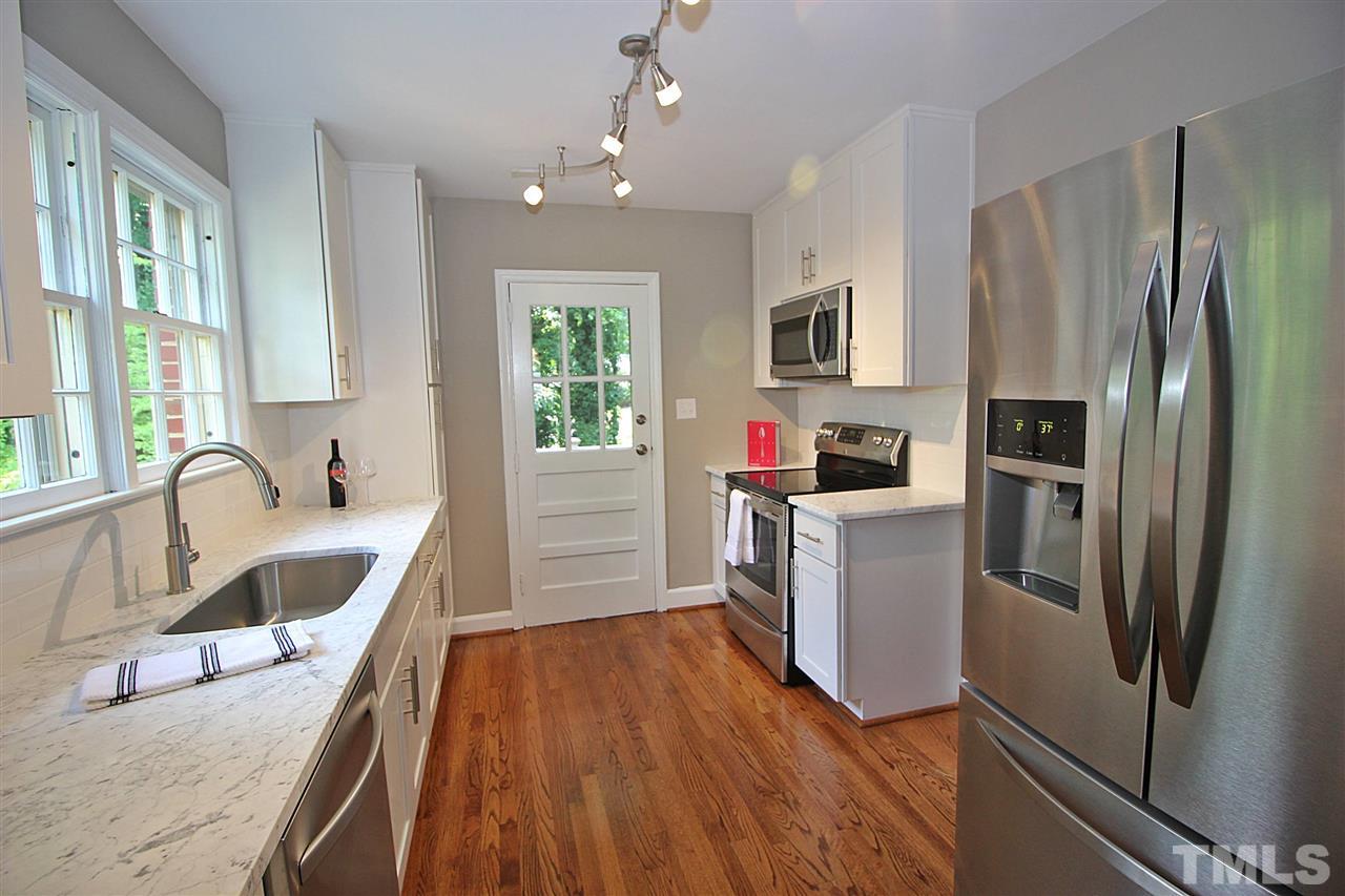 1204 Mitchell Street Raleigh, NC 27607 - Photo 9 of 22 a kitchen with refrigerator a sink and dishwasher