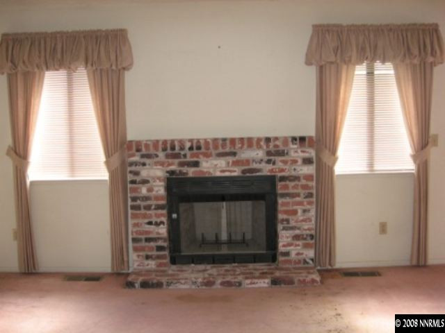 5950 Walnut Creek Road Reno, NV 89523 - Photo 4 of 7 a living room with a fireplace and a window