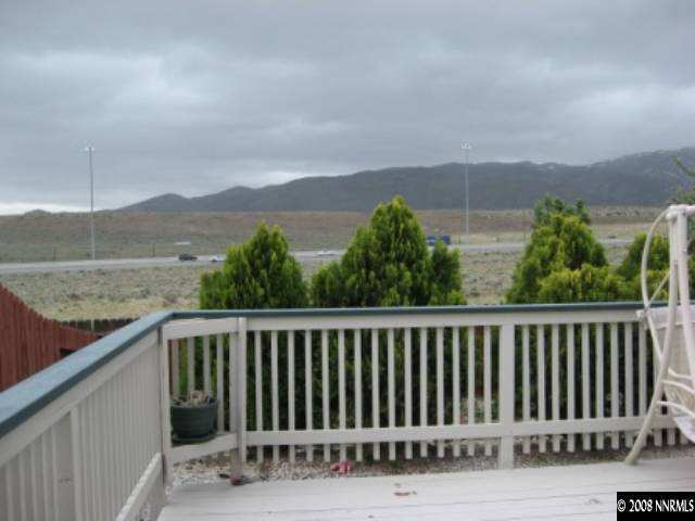 5950 Walnut Creek Road Reno, NV 89523 - Photo 6 of 7 a balcony with wooden floor and fence
