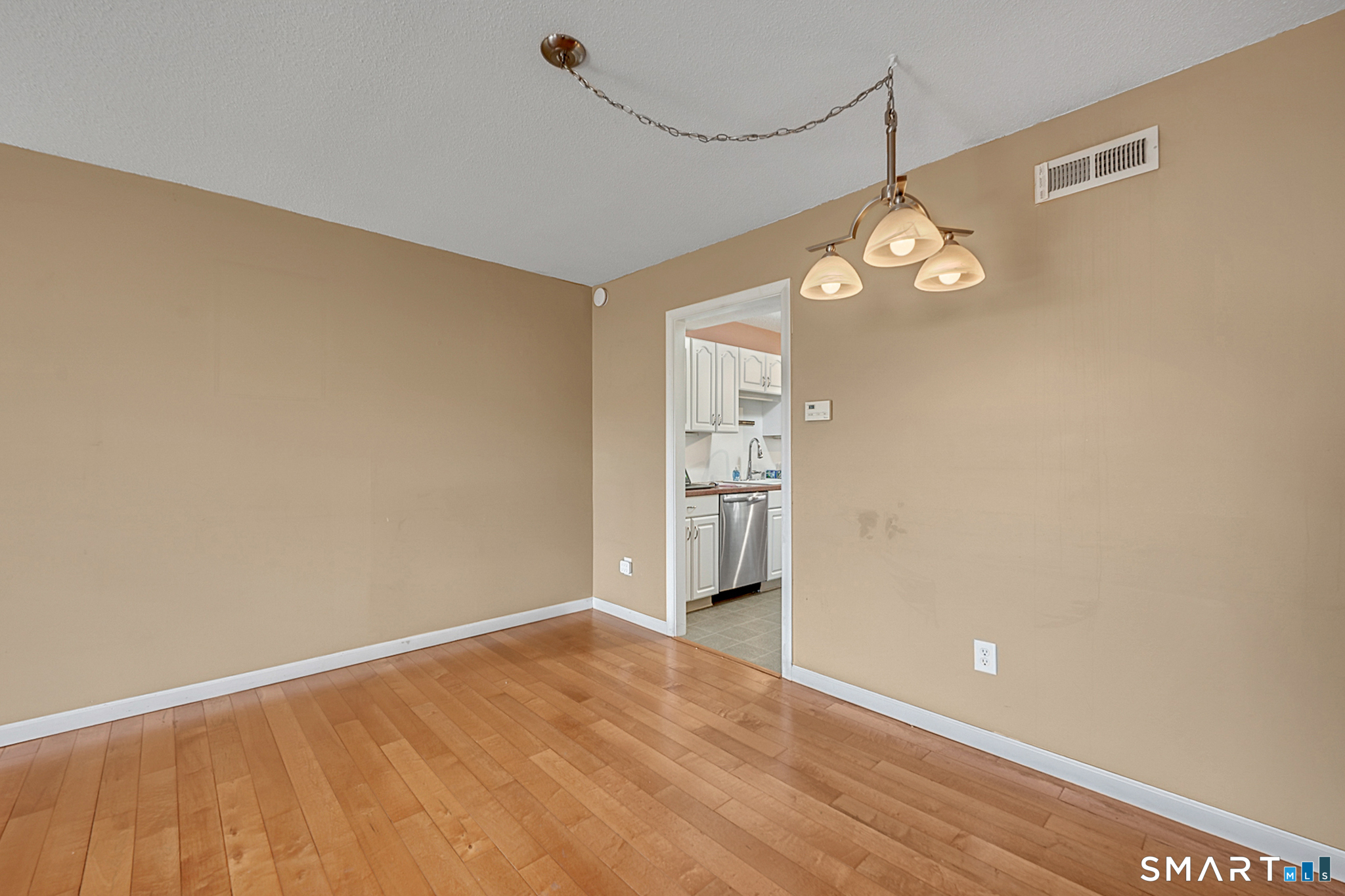 160 Brittany Farms Road, Unit F New Britain, CT 06053 - Photo 11 of 35 a view of empty room with wooden floor and fan
