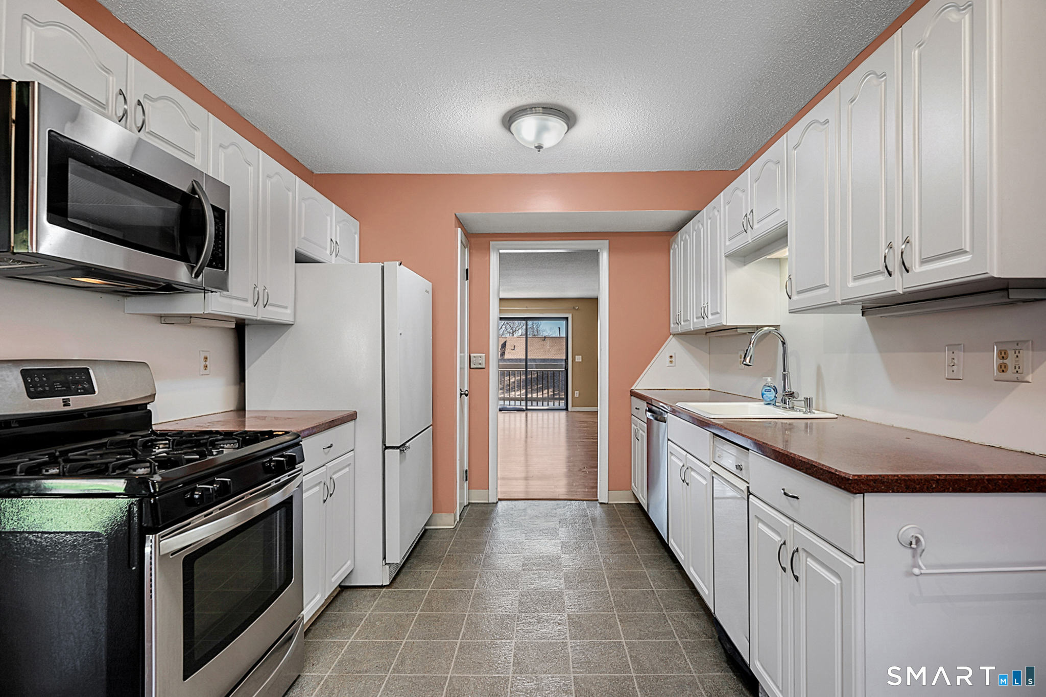 160 Brittany Farms Road, Unit F New Britain, CT 06053 - Photo 12 of 35 a kitchen with stainless steel appliances a sink dishwasher a stove and a microwave oven with cabinets