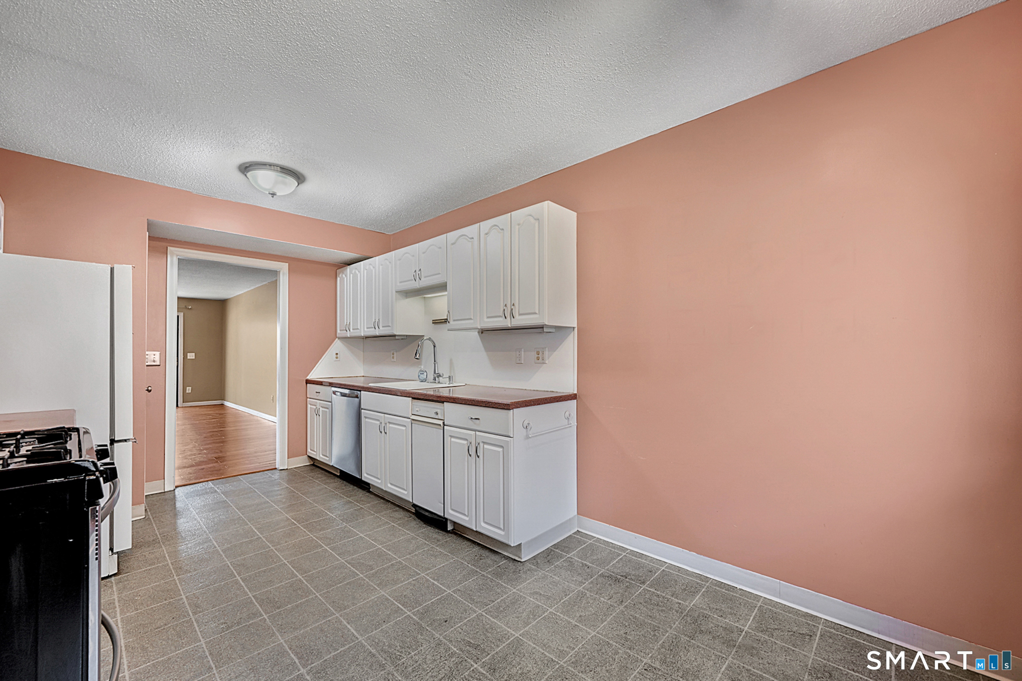 160 Brittany Farms Road, Unit F New Britain, CT 06053 - Photo 13 of 35 a kitchen with granite countertop white cabinets and white appliances