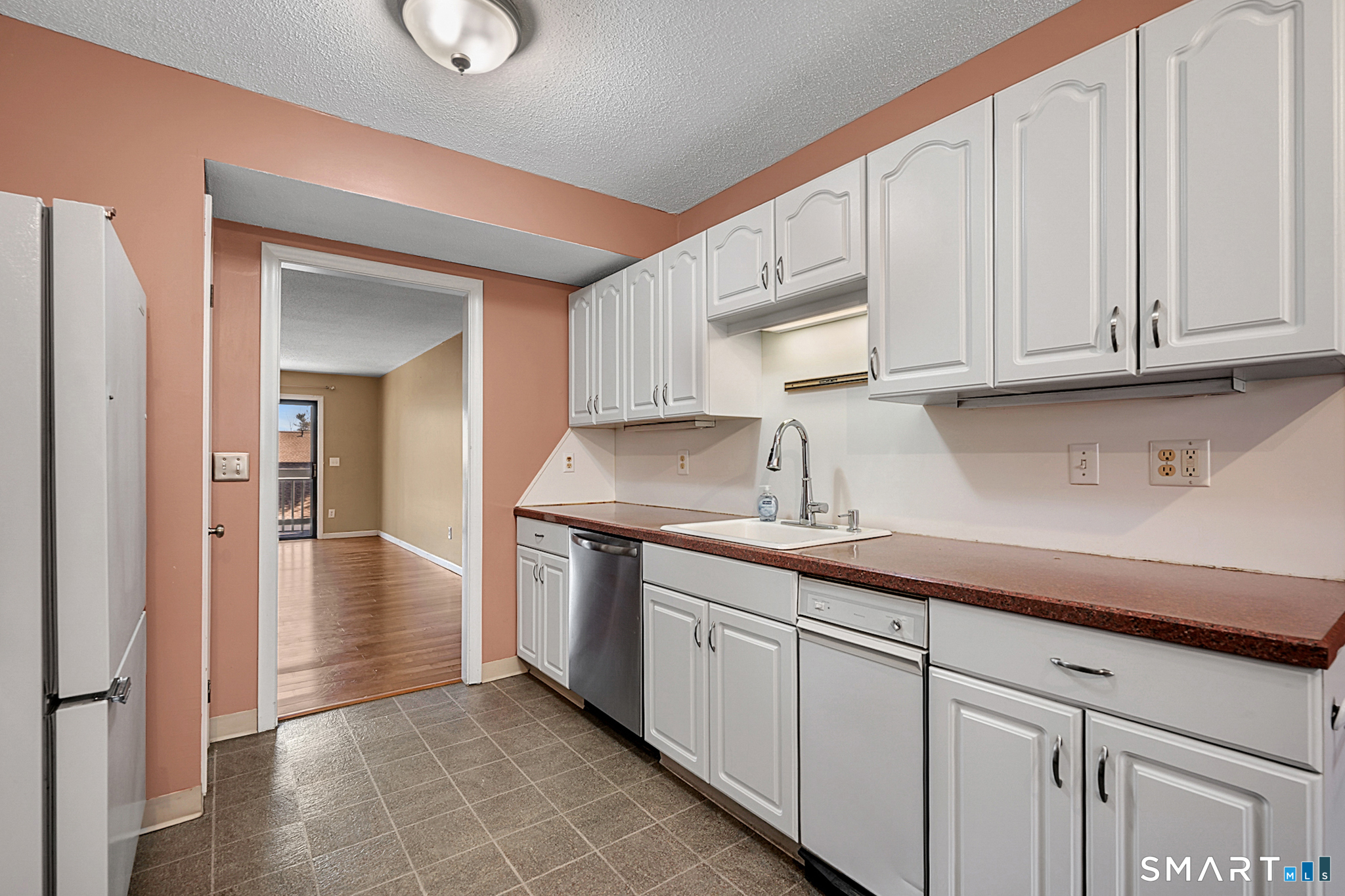 160 Brittany Farms Road, Unit F New Britain, CT 06053 - Photo 14 of 35 a kitchen with granite countertop white cabinets and sink