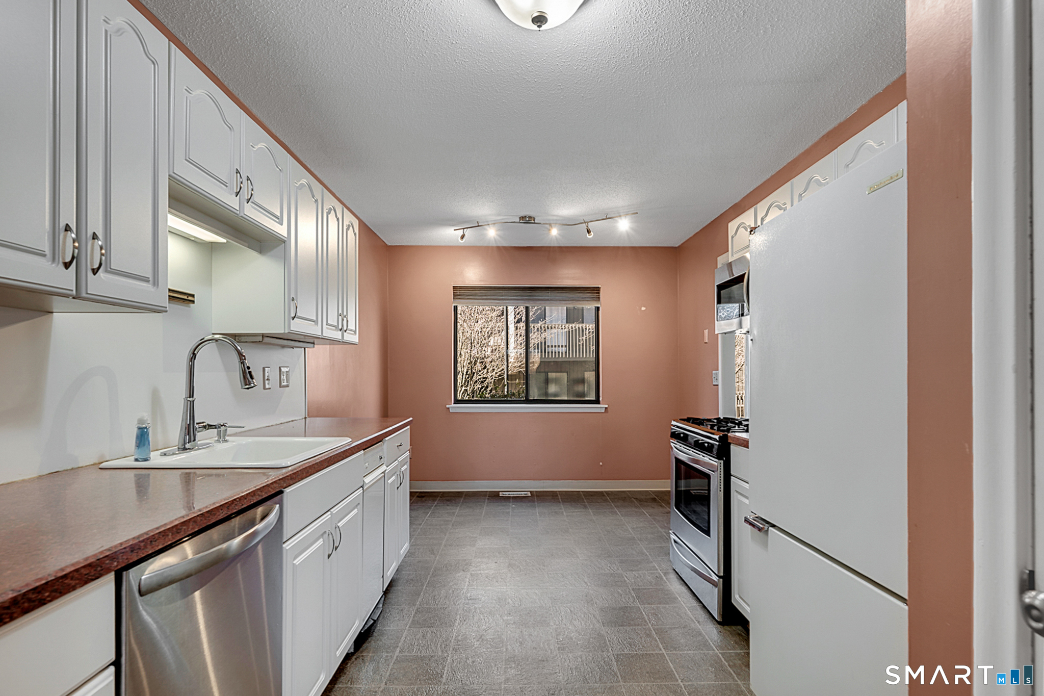 160 Brittany Farms Road, Unit F New Britain, CT 06053 - Photo 15 of 35 a view of a kitchen with kitchen island a sink stainless steel appliances and cabinets