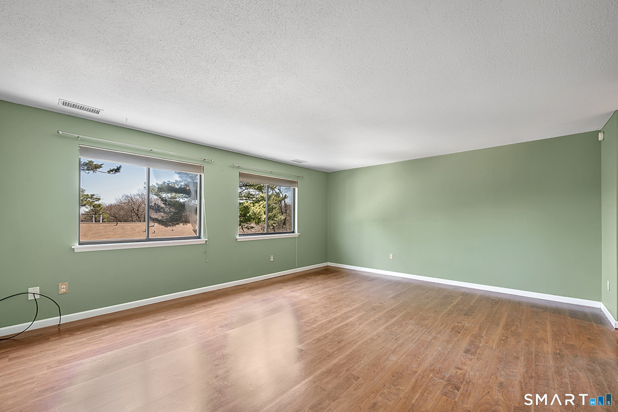 160 Brittany Farms Road, Unit F New Britain, CT 06053 - Photo 19 of 35 a view of an empty room with painting on the wall and a window