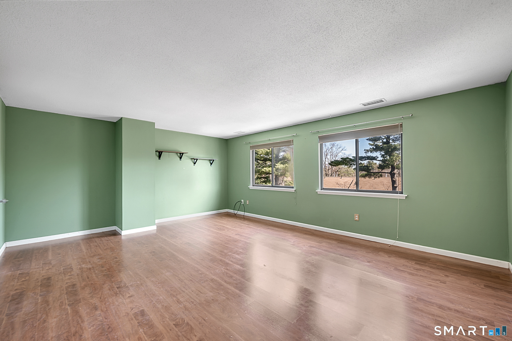 160 Brittany Farms Road, Unit F New Britain, CT 06053 - Photo 20 of 35 an empty room with closet and windows