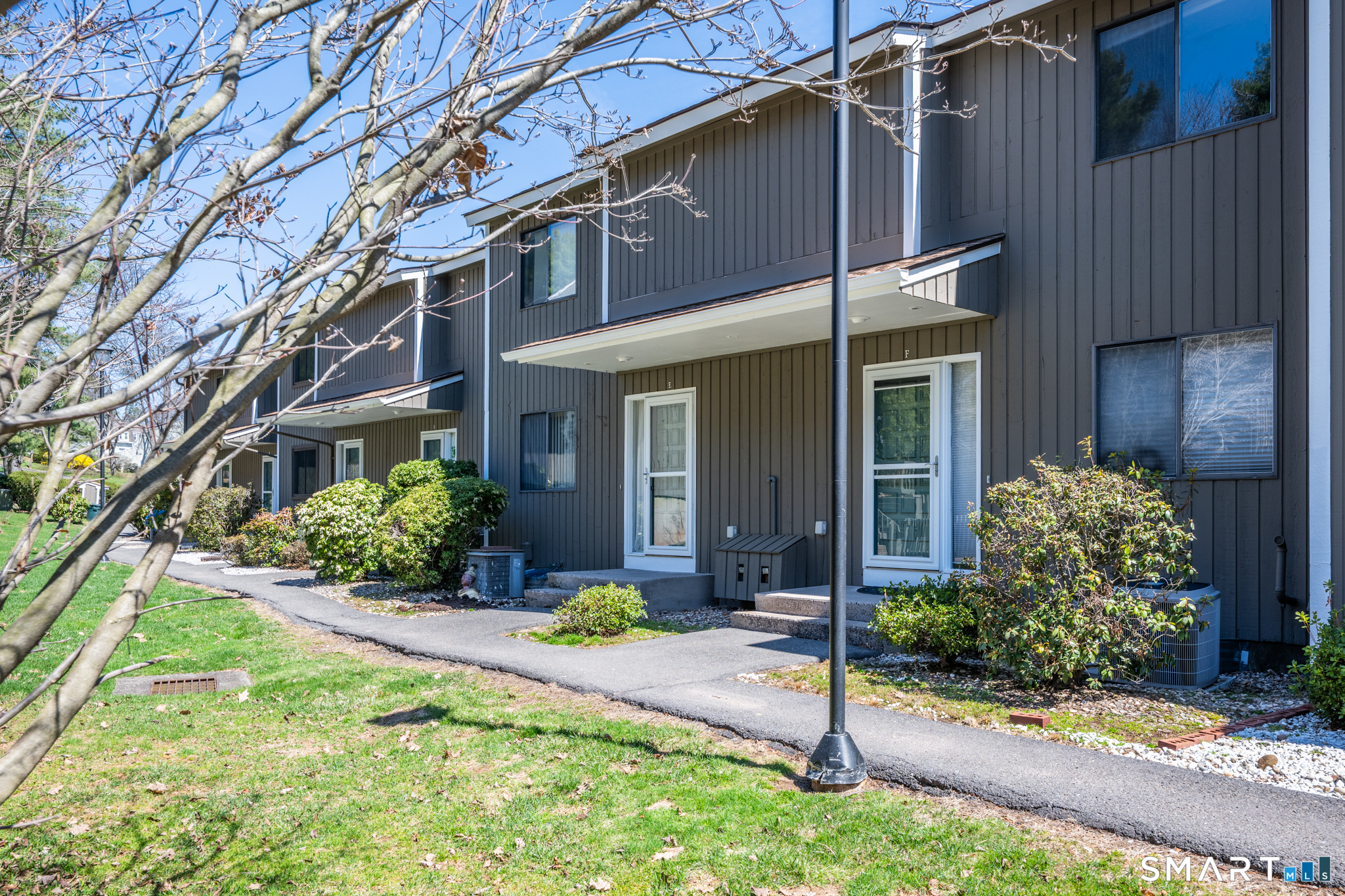 160 Brittany Farms Road, Unit F New Britain, CT 06053 - Photo 2 of 35 a front view of a house with a yard