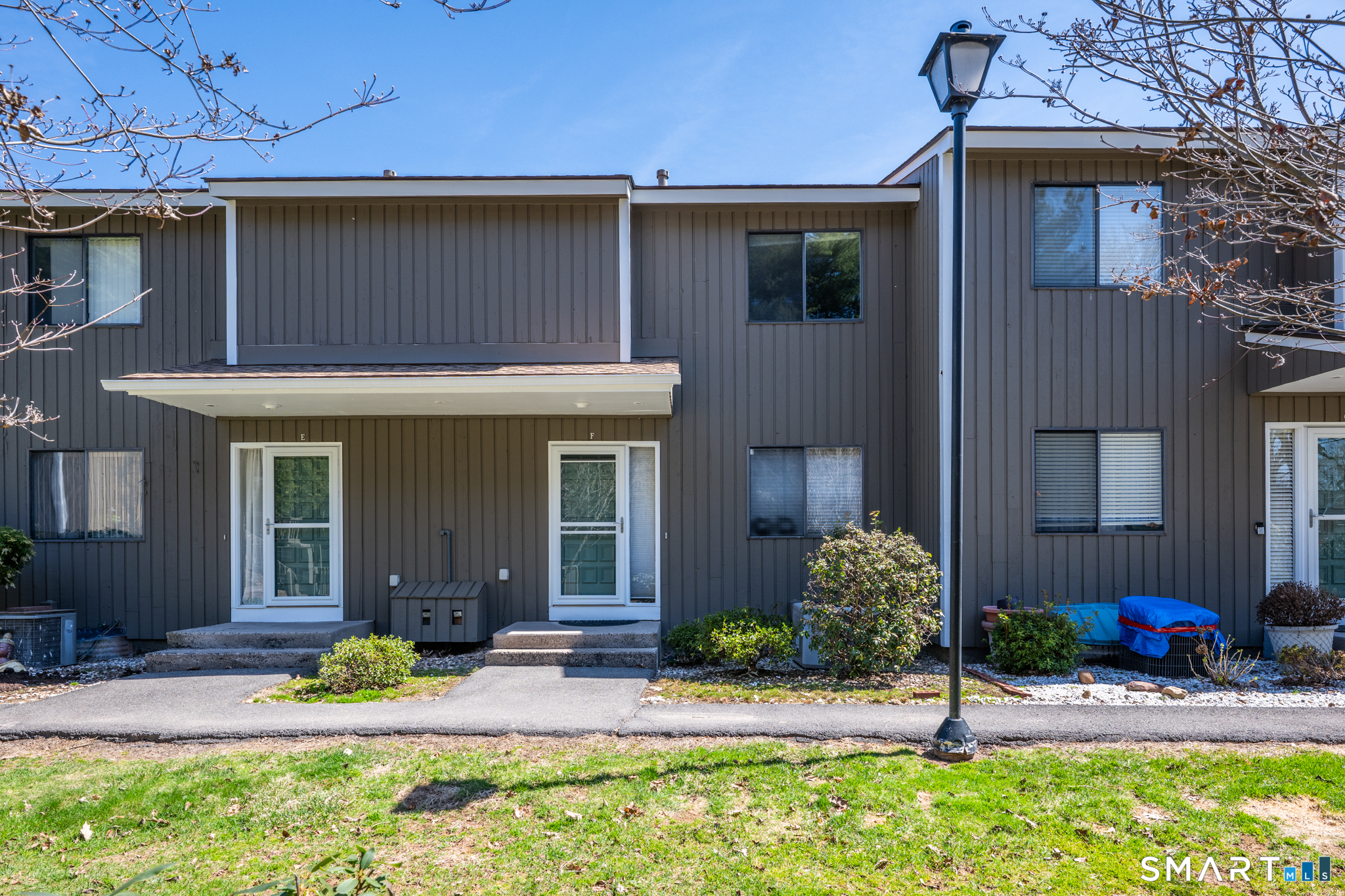 160 Brittany Farms Road, Unit F New Britain, CT 06053 - Photo 3 of 35 a front view of a house with garden