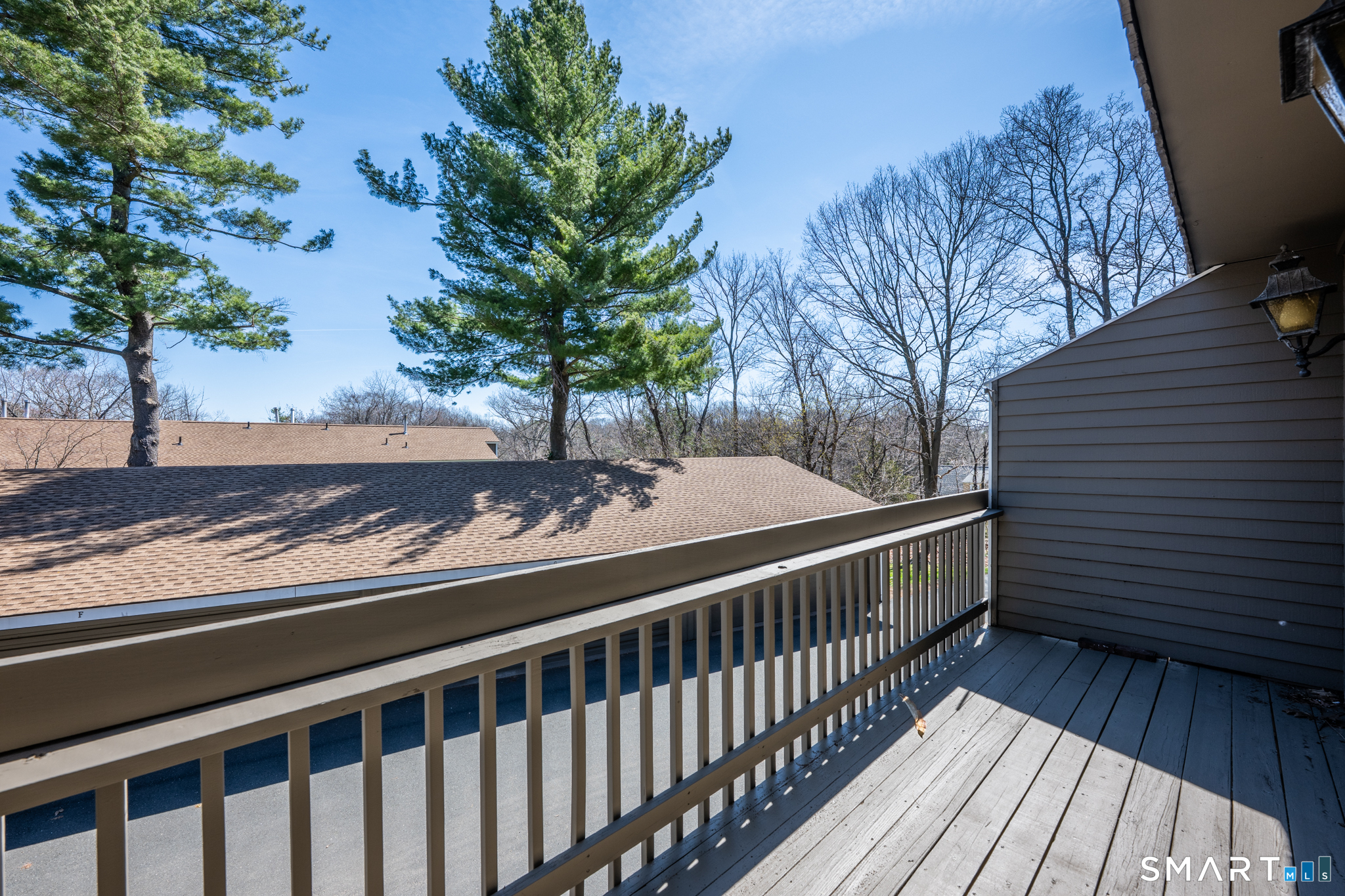 160 Brittany Farms Road, Unit F New Britain, CT 06053 - Photo 32 of 35 a view of a balcony with wooden floor and fence