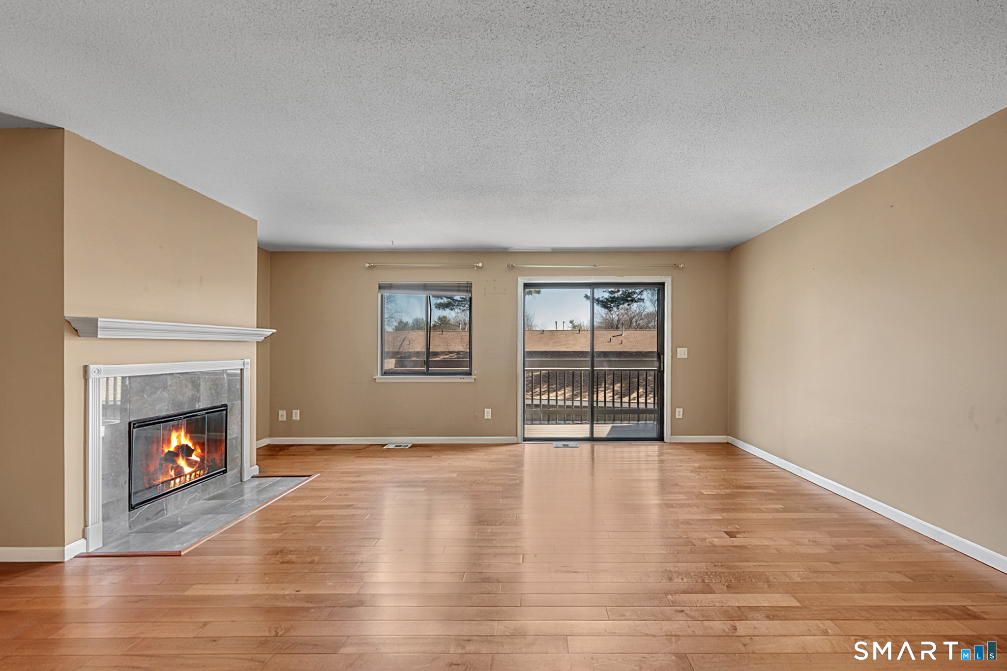 160 Brittany Farms Road, Unit F New Britain, CT 06053 - Photo 9 of 35 a view of an empty room with window and fireplace