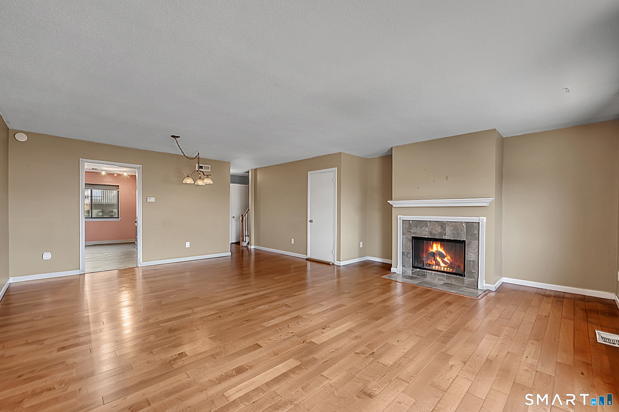 160 Brittany Farms Road, Unit F New Britain, CT 06053 - Photo 10 of 35 wooden floor fireplace and natural light in room