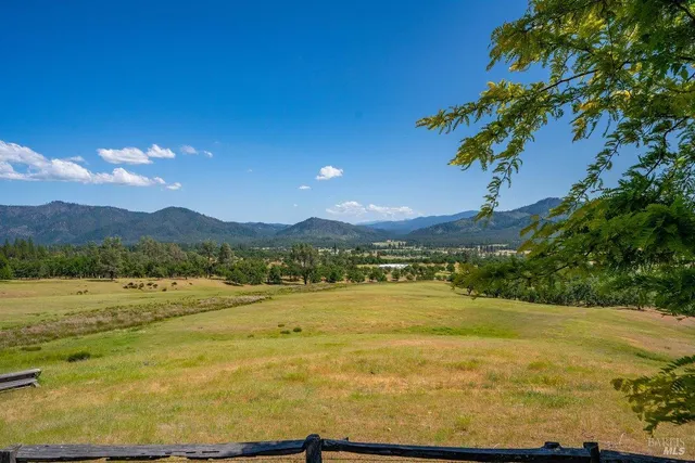 a view of a green field with sitting area