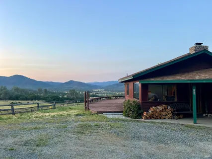 a view of a house with a yard and sitting area