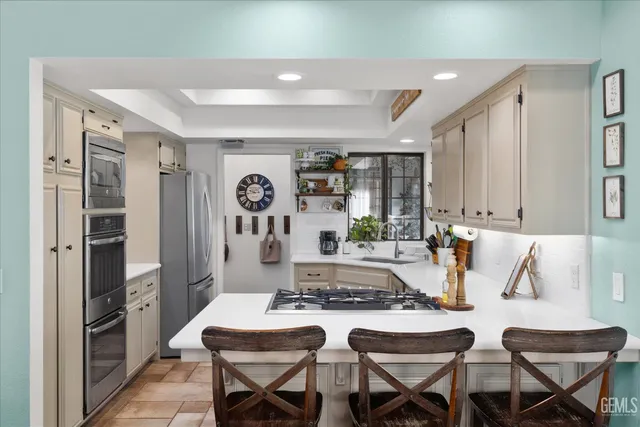 a large kitchen with lots of counter space and windows