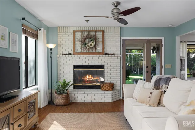 a living room with furniture potted plant and a flat screen tv