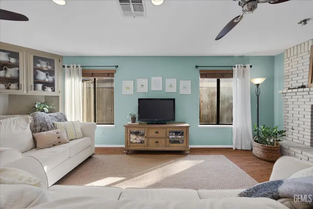 a bedroom with a bed chandelier and a window