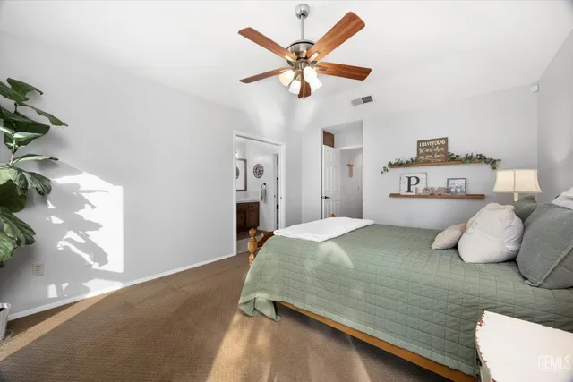 a spacious bathroom with a toilet a sink and a mirror