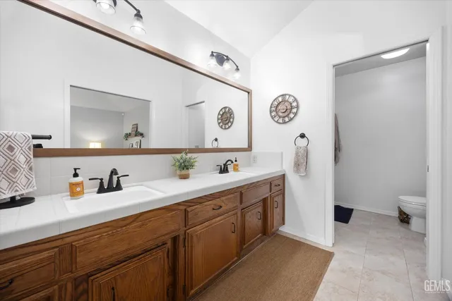 a spacious bathroom with a double vanity sink and a mirror