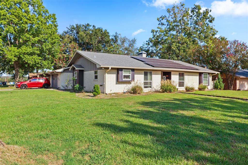 124 Lou Street Sulphur Springs, TX 75482 - Photo 2 of 33 a front view of a house with a garden