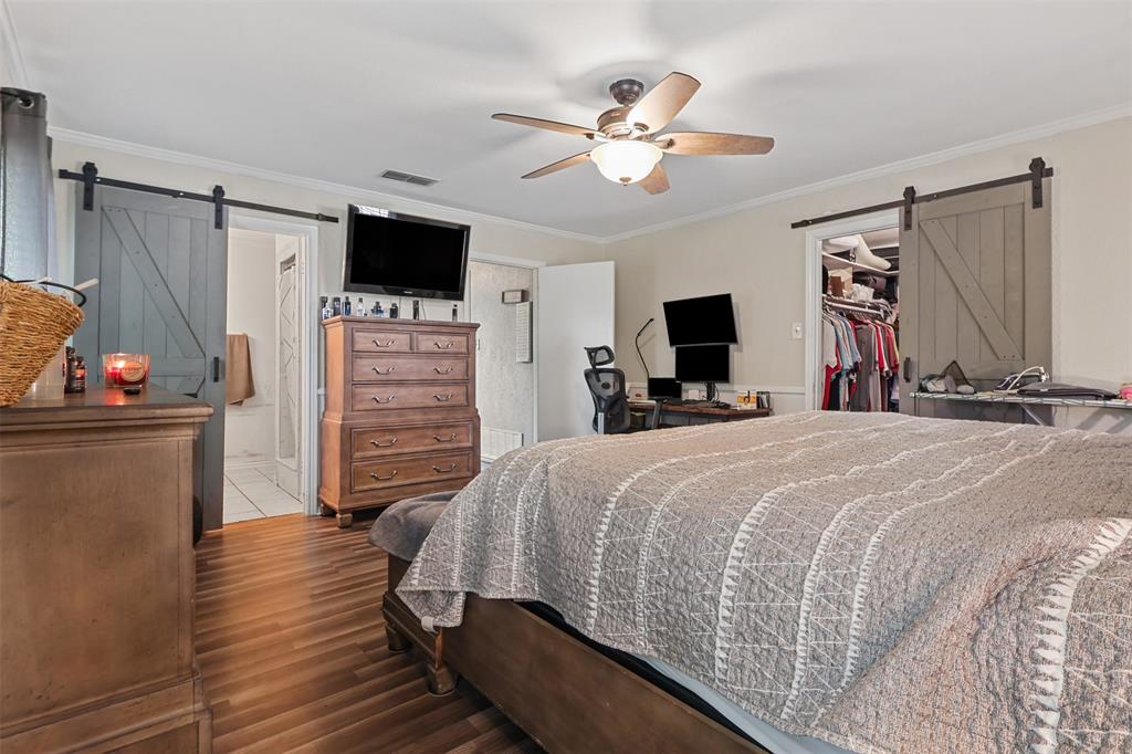 124 Lou Street Sulphur Springs, TX 75482 - Photo 27 of 33 a bed room with a bed a television and a fireplace