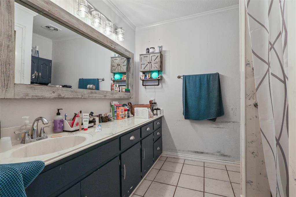124 Lou Street Sulphur Springs, TX 75482 - Photo 28 of 33 a kitchen with a refrigerator and cabinets