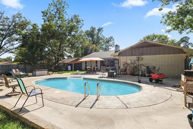 a view of a swimming pool with lounge chairs
