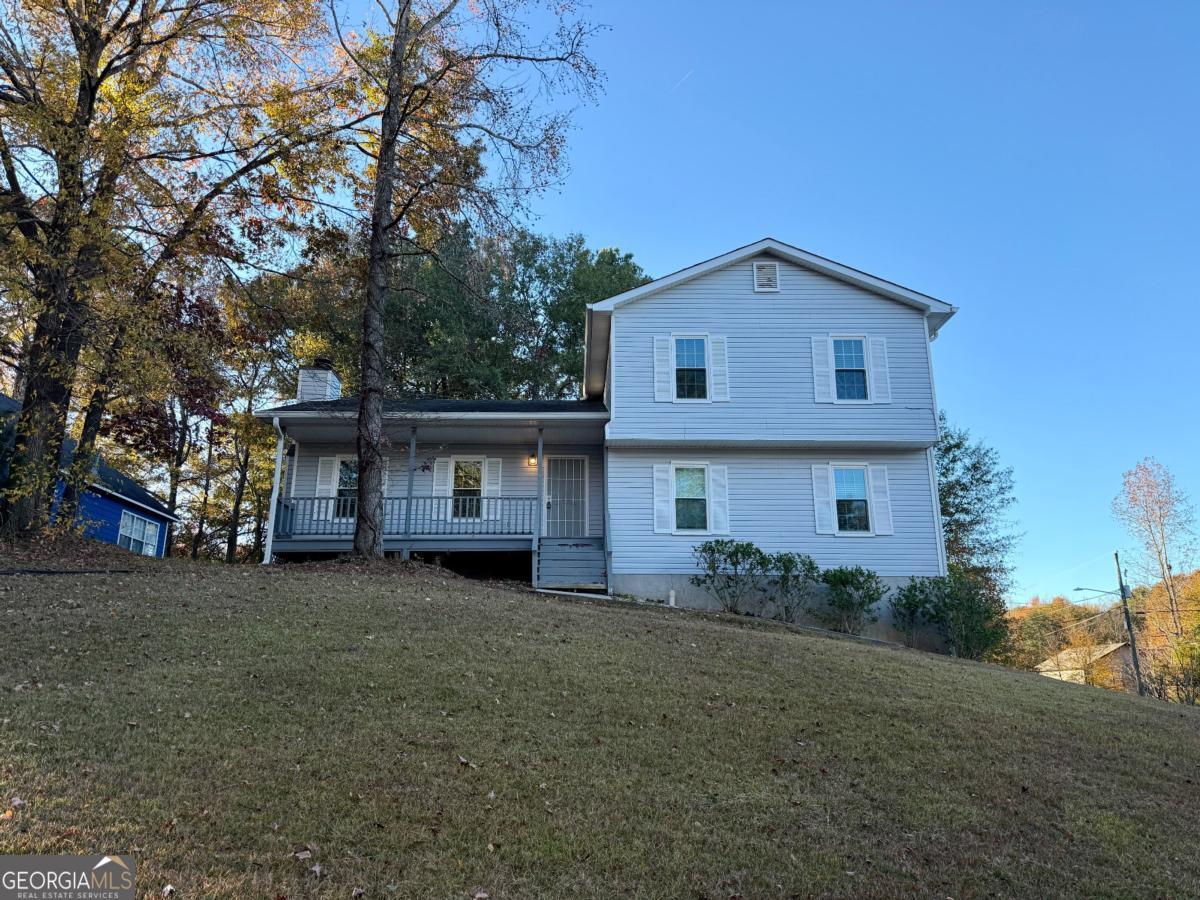 a front view of a house with a garden