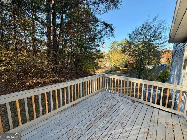 a balcony with wooden floor and fence