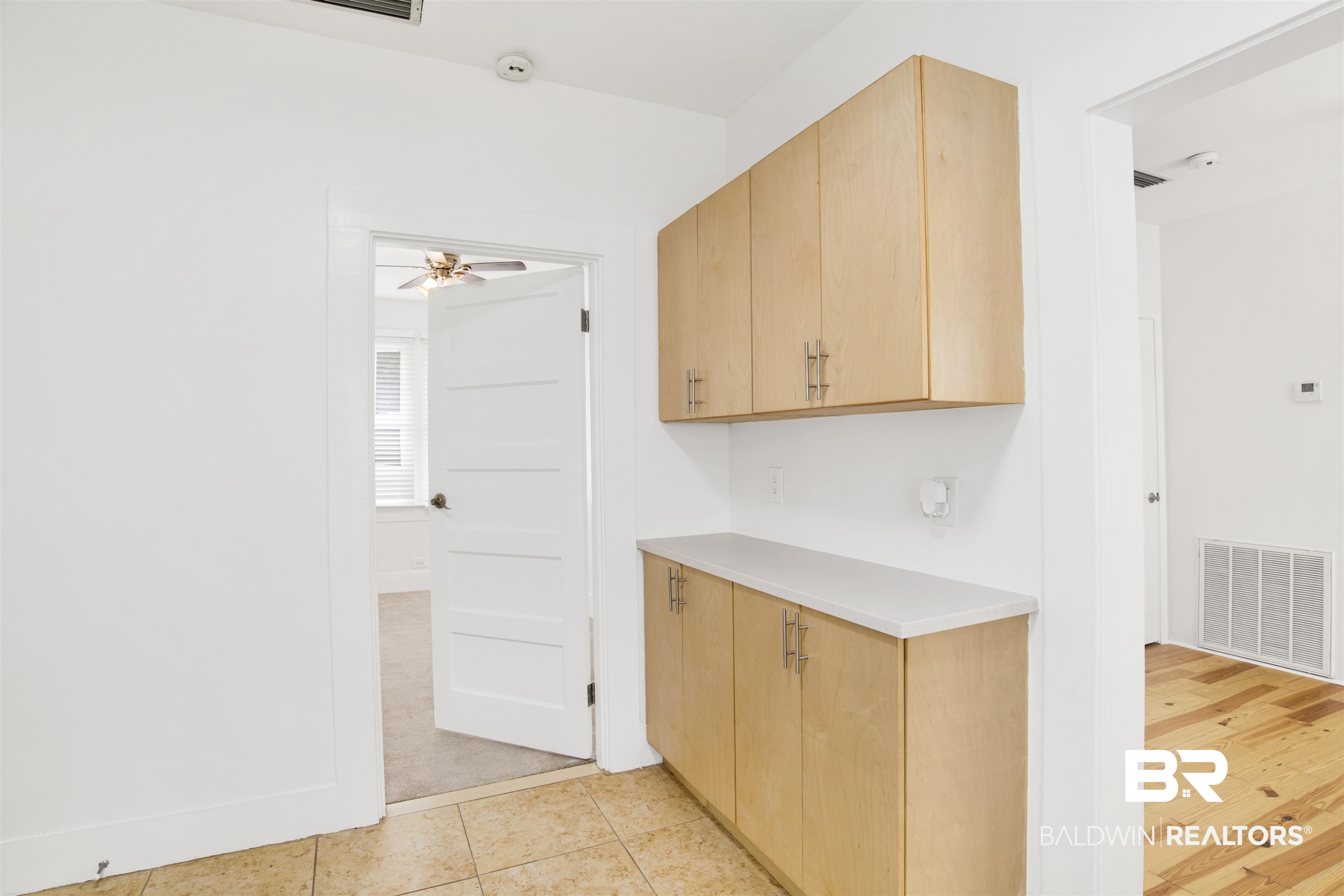 507 Holcombe Avenue Mobile, AL 36606 - Photo 14 of 28 Kitchen featuring light countertops, light brown cabinetry, a ceiling fan, and light tile patterned floors